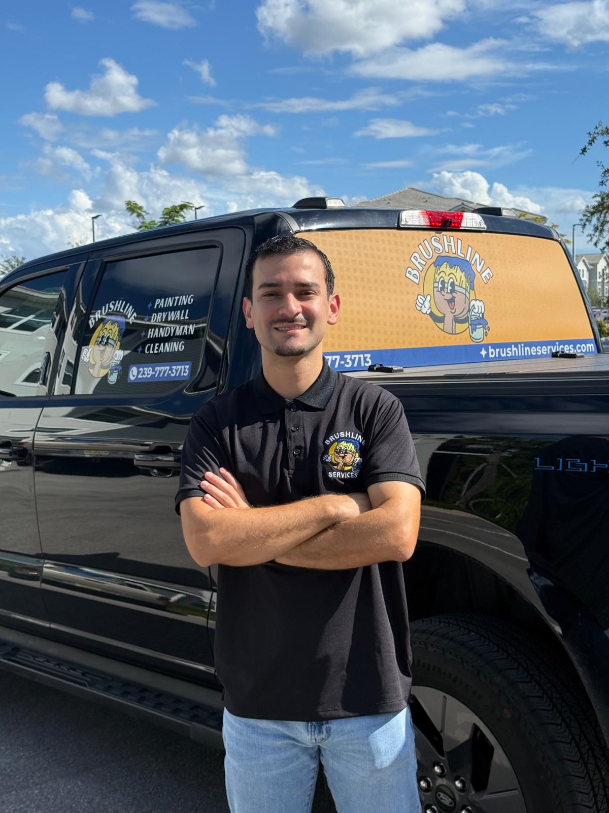 Brushline Services owner standing in front of the business truck